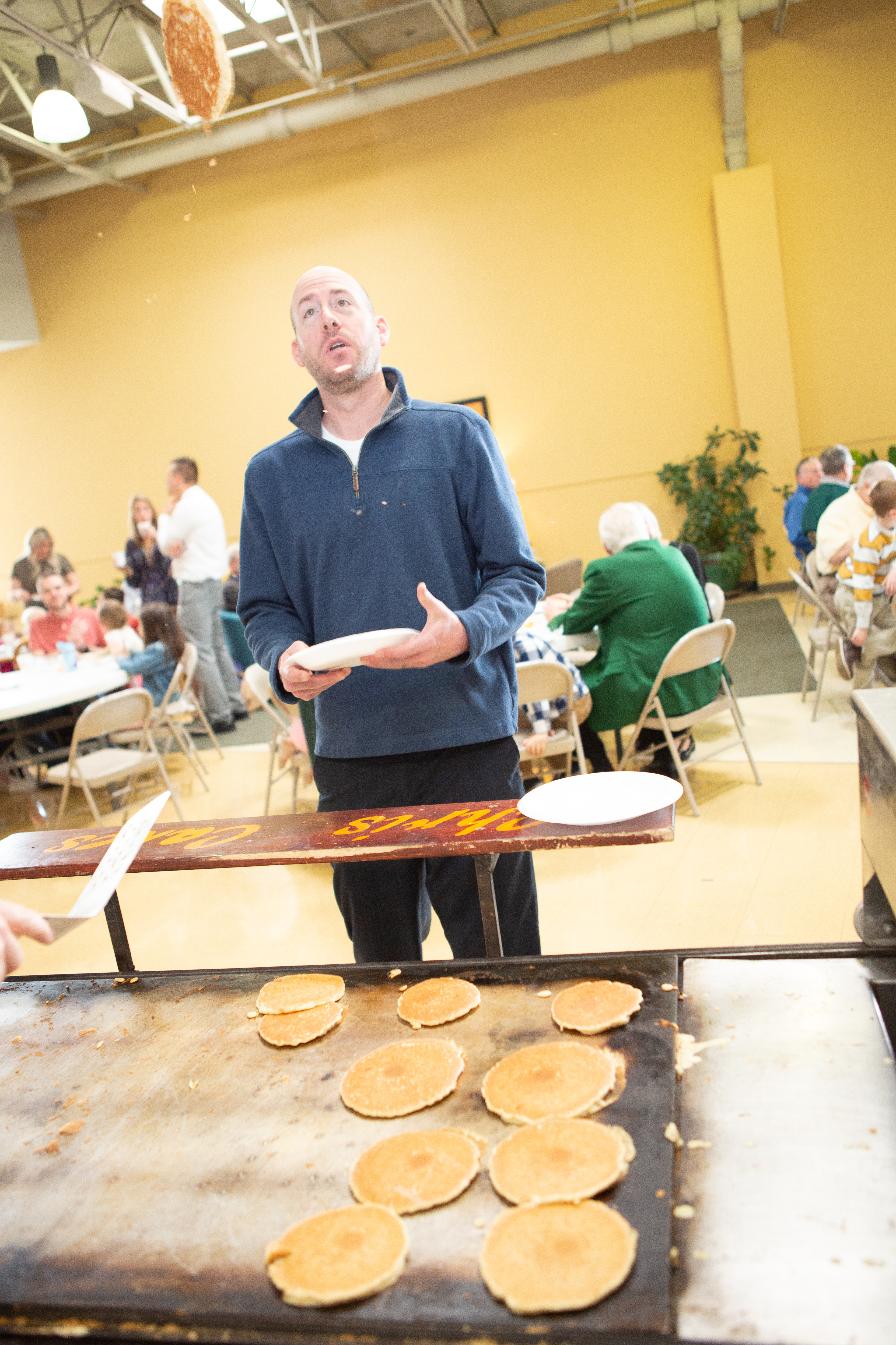 Professional pancake flipping demonstration at DFW corporate event